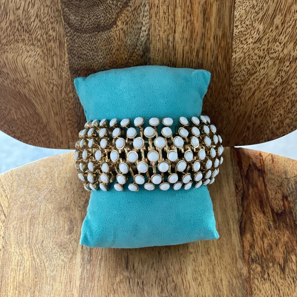 Gold and white stretch bracelet.